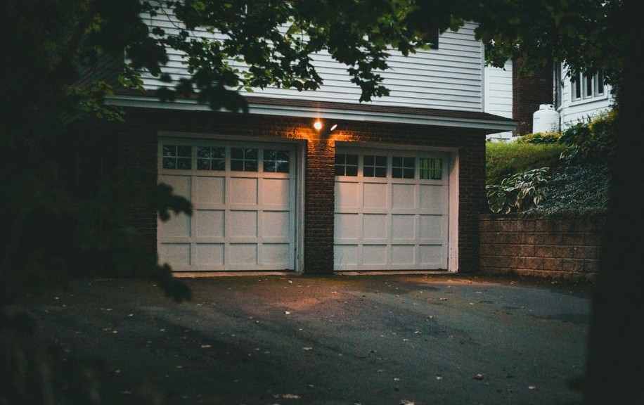 Warm evening view of a suburban garage with soft lighting creating a cozy atmosphere